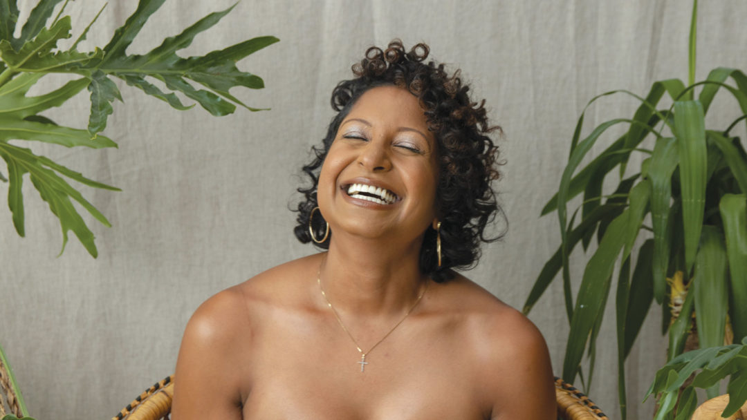 Kristal smiling while showing her mastectomy scar